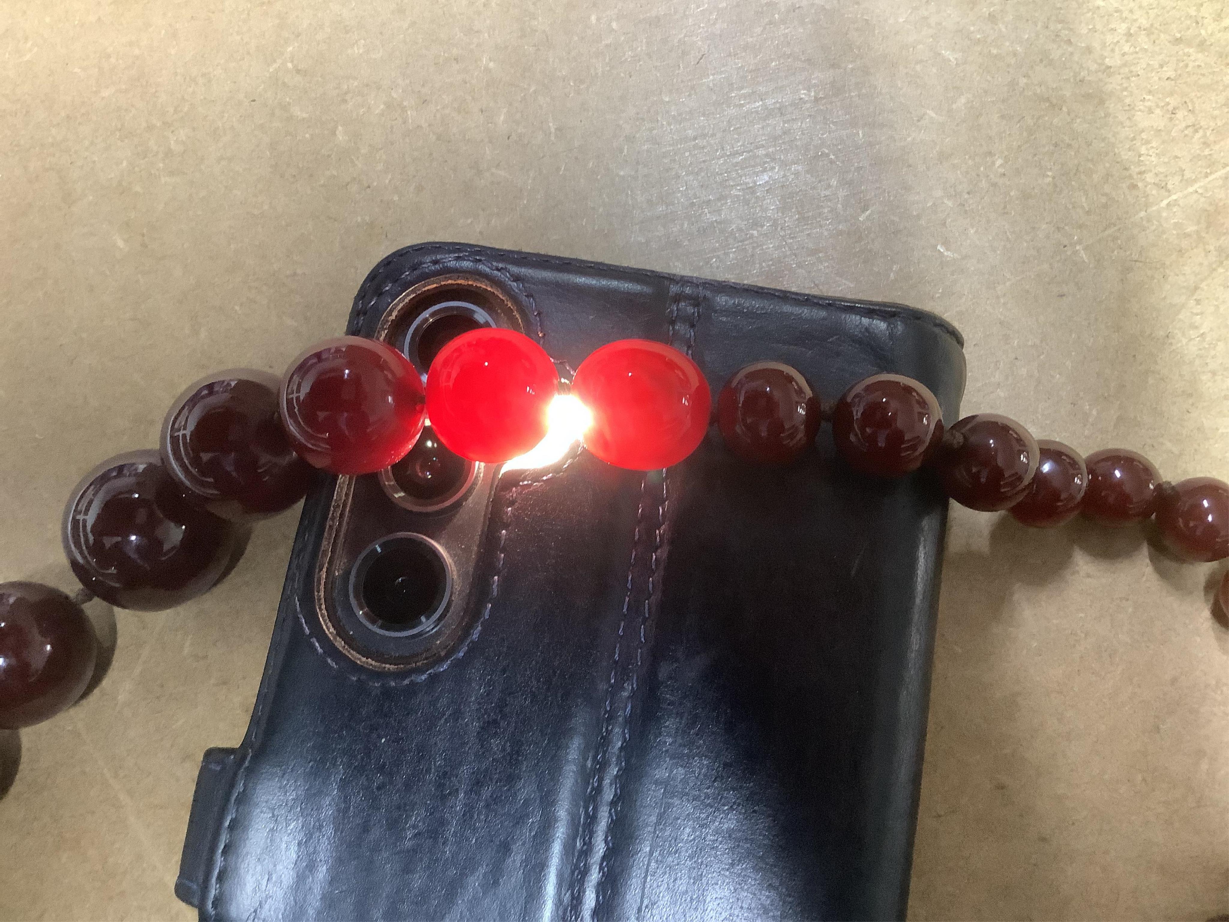 A cherry bakelite 'amber' necklace, composed of graduated spherical beads measuring approximately 6.7-23mm diameter, length approximately 86cm, gross weight 72 grams.